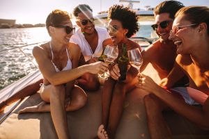 Multiracial,Group,Of,People,Toasting,Drinks,On,The,Yacht,Deck